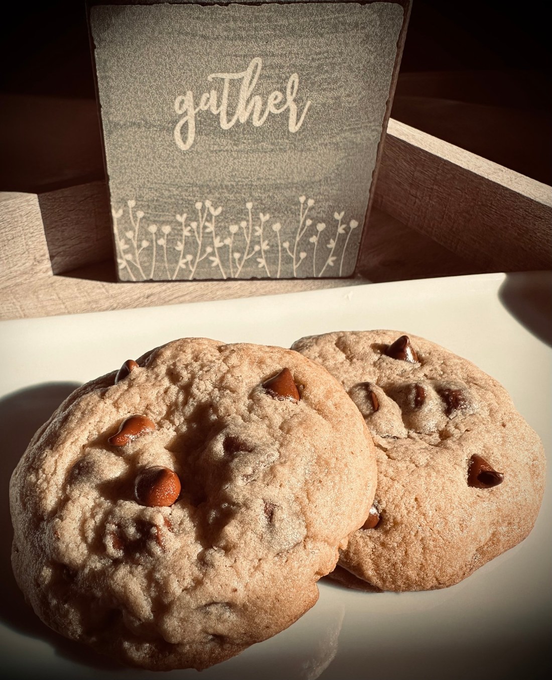 Nook & Gather chocolate chip cookies beside a wooden sign reading gather